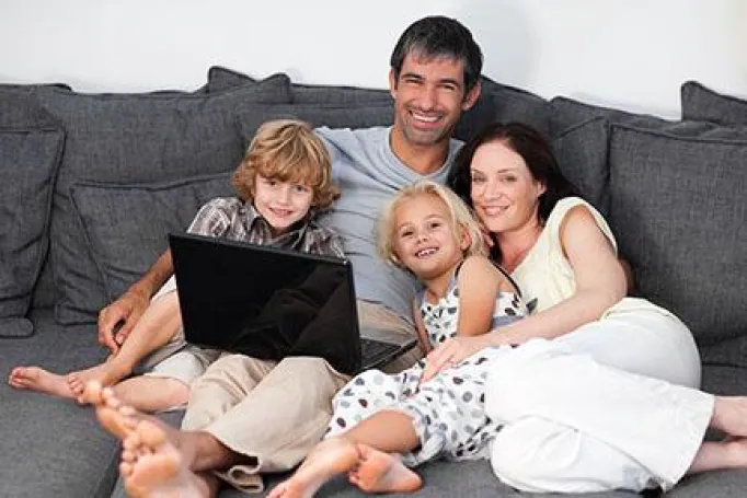 family on a sofa with laptop 0