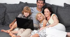 family on a sofa with laptop 0